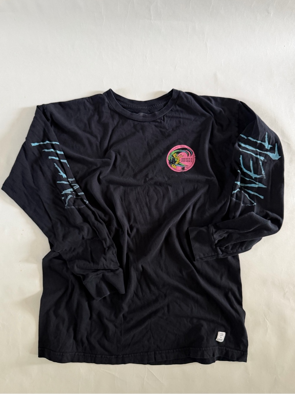 O’Neill Black Long Sleeve Graphic Tee with 80’s classic Pink & Teal Design - Picture 1 of 4